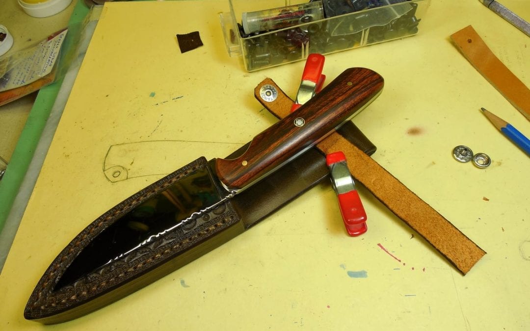 applying keeper strap on sheath