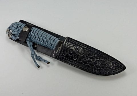 P-2 Titanium colored paracord utility knife inside custom fitted leather sheath