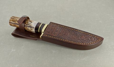 Elk horn knife inside handmade leather sheath